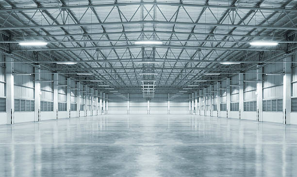 Empty factory Empty factory with concrete floor, night scene. industrial building stock pictures, royalty-free photos & images