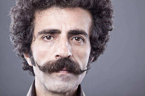 istock Adult man portrait with handle bar mustache 516592051