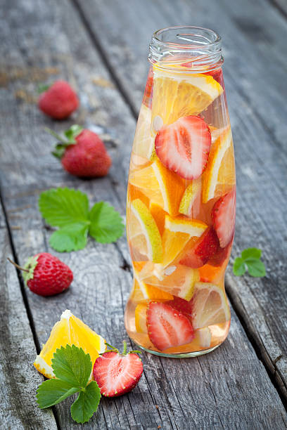 istock Fresh fruit detox water in bottle on wooden table 516592191