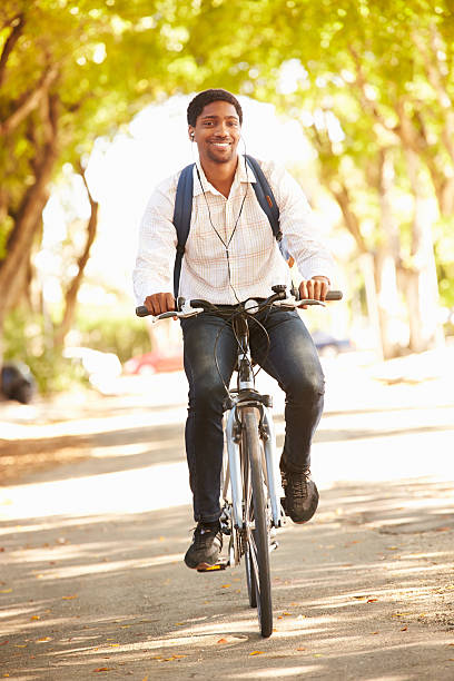 istock Young Man Cycling Along Street To Work 516592437