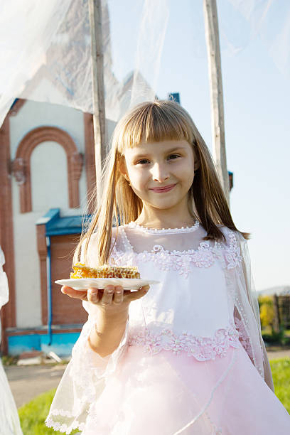 istock girl  on a orthodox church background. 516592459