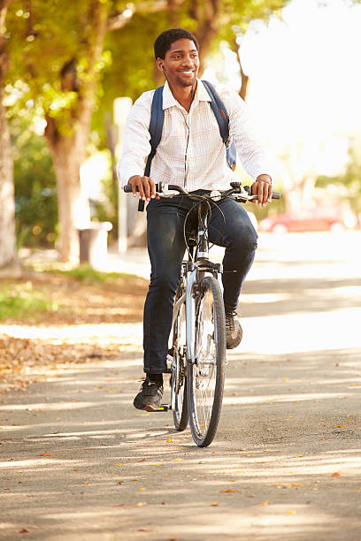 istock Young Man Cycling Along Street To Work 516592571
