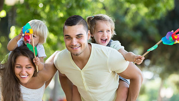 istock Family with toy windmills at park 516592607