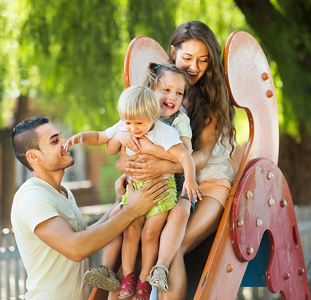 istock Parents helping kids on slide 516592653