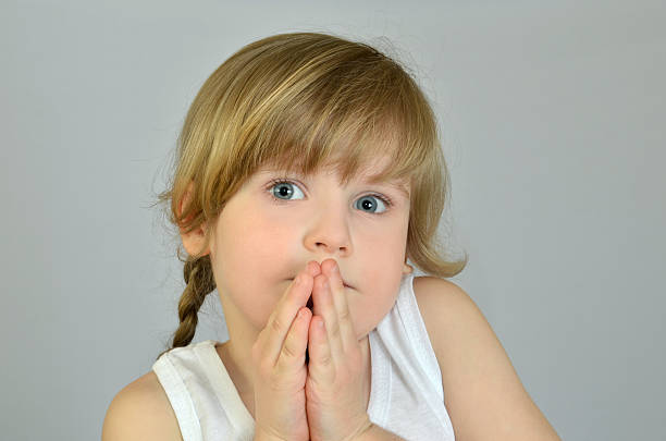 istock Cute little girl folded her hands in prayer 516600254