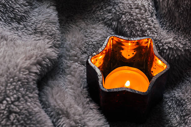 istock Cosy and soft winter background,candles on a blanket 516600820