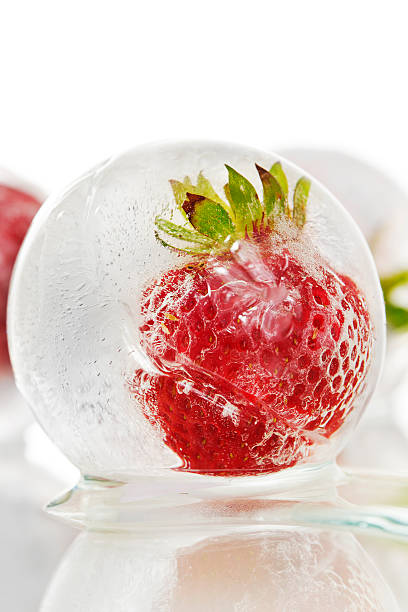 istock Strawberry frozen inside an ice ball 516602302