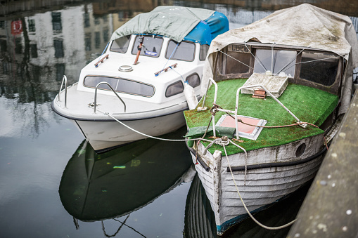 Copenhagen, Denmark - March 19, 2016: Two small boats moored on Christianshavn Canal, Copenhagen, Denmark