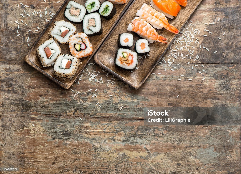 Traditional japanese food. Sushi rolls, maki, nigiri Traditional japanese food. Sushi rolls, maki, nigiri on wooden background Sushi Stock Photo