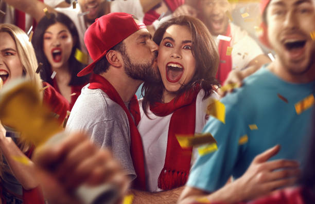 istock Sport fans: Man kisses woman 516602756