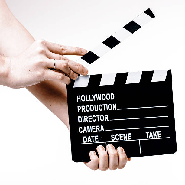 istock Movie flapper in woman´s hands on white background 516603556