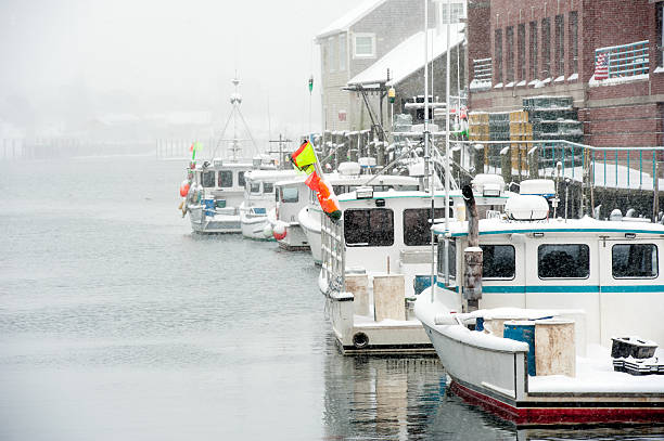 Lobster boats in Portland, Maine harbor after a snow storm stock photo