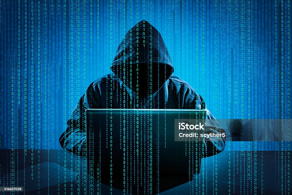 Computer crime concept. Hacker using laptop. Hacking the Internet. Computer Hacker Stock Photo