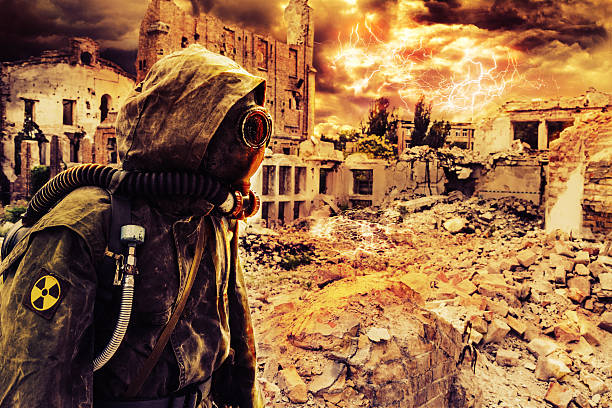 Post apocalypse sole survivor Post apocalypse. Sole survivor in tatters and gas mask on the ruins of the destroyed city radioactive contamination stock pictures, royalty-free photos & images