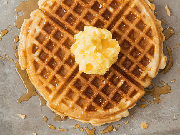 istock rustic traditional waffle with butter and maple syrup 516608072