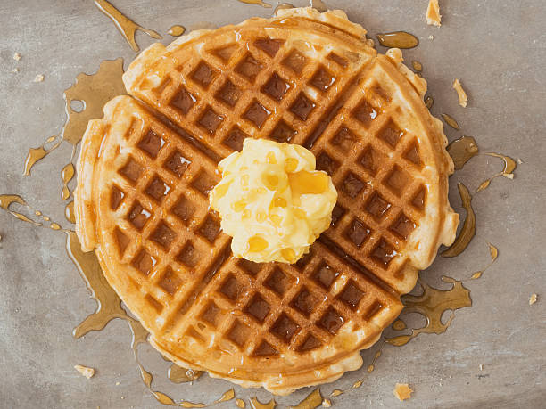 istock rustic traditional waffle with butter and maple syrup 516608316