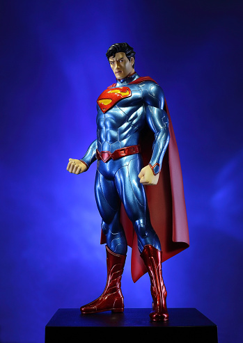 Whitby, Ontario, Canada - March 15, 2016: Superman, the DC comics superhero stands imposingly against a dramatic background. The PVC figure is by Kotobukiya.