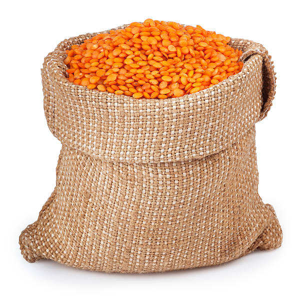 istock red lentils in bag on white background 516609362