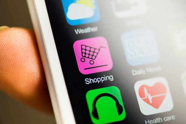 Hand holding phone, shopping app on screen