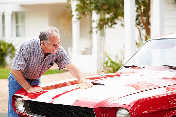 Retired Senior Man Cleaning Restored Car Retired Senior Man Cleaning Restored Car. Polishing Bonnet, Smiling collectors car stock pictures, royalty-free photos & images
