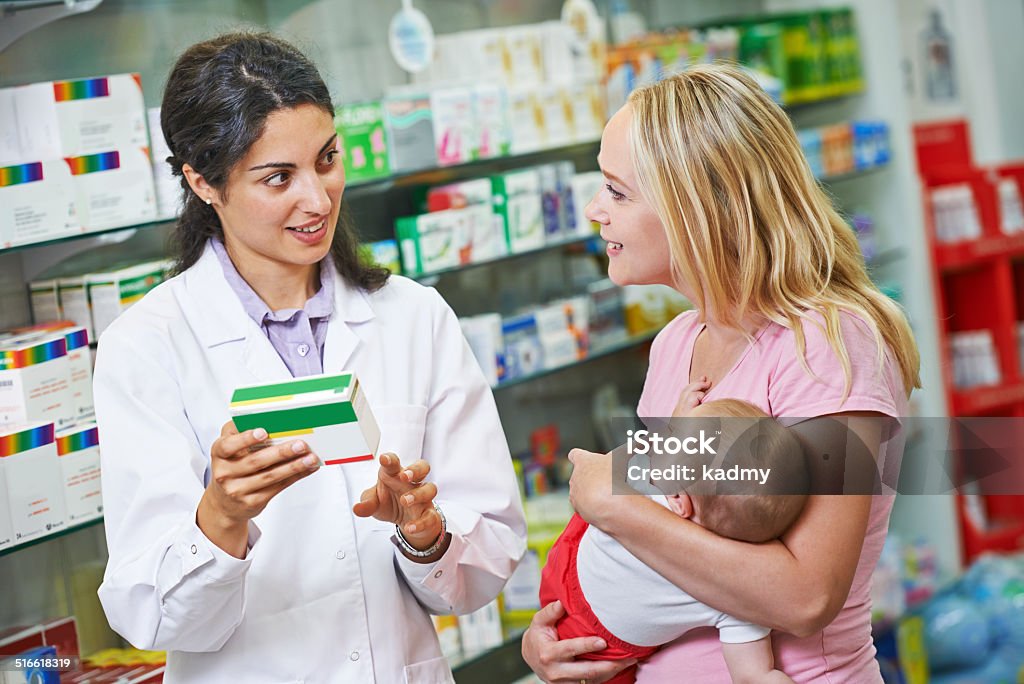 Pharmacy chemist, mother and child in drugstore Cheerful pharmacist chemist woman giving vitamins to child girl in pharmacy drugstore Pharmacy Stock Photo