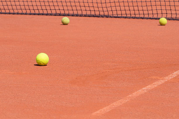 istock Tennis balls and net 516620357
