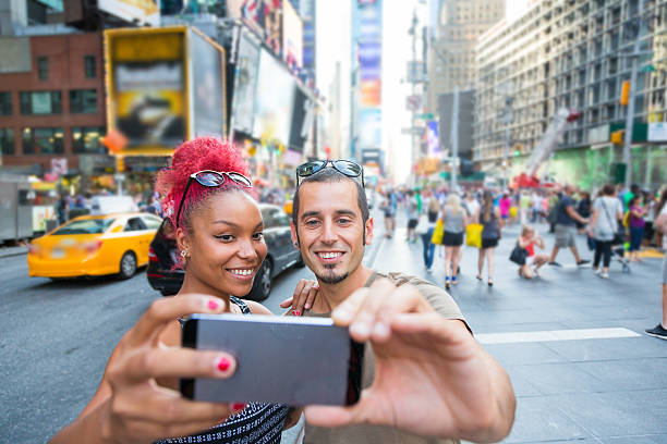 istock Young Couple Taking Selfie in Times Square 516621217