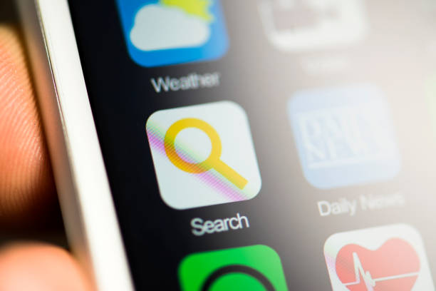 istock Hand holding phone, search app on screen 516621378