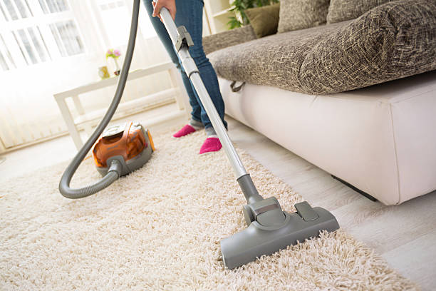 istock Cleaning carpet in living room 516622260