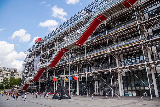 Centre Pompidou in Paris, France Paris, France - August 08, 2014: Centre Pompidou with unidentified people. The modern museum building is designed in style of hightech architecture by architects Richard Rogers, Renzo Piano and Gianfranco Franchini. pompidou center stock pictures, royalty-free photos & images