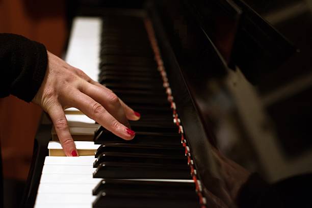 istock Woman playing piano keys. 516628782