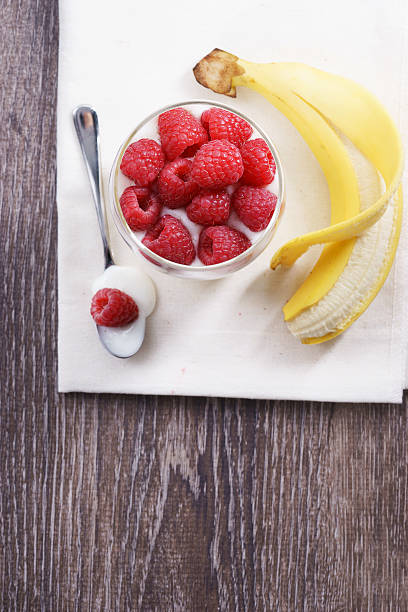 istock raspberries, banana and yogurt. 516635496
