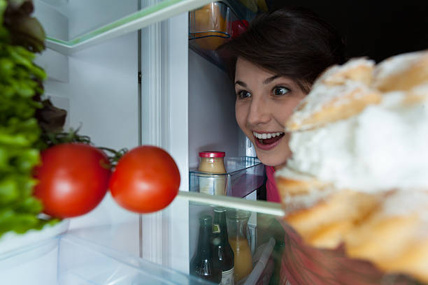 istock Happy girl looking into the fridge 516635871