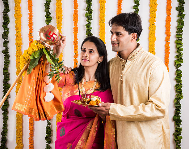 istock smart indian couple performing gudhi padwa puja 516636328