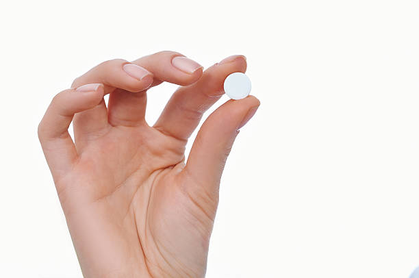 istock Woman hand with pill 516636533