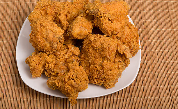 istock White Plate of Fried Chicken on Bamboo Placemat 516636955