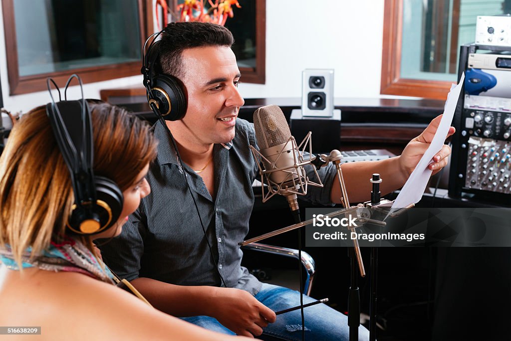 Record producer Record producer showing young singer the right way to perform the song Noise Stock Photo