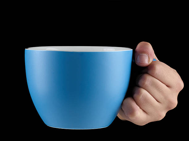 istock Orange - blue color cup - mug on black background. 516639069