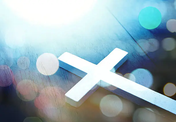 Cross on wood and bokeh background