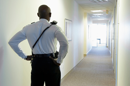 Security guard in an office corridor