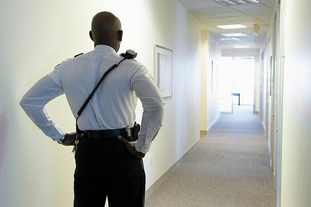 Security guard in an office corridor Security guard in an office corridor security guard photos stock pictures, royalty-free photos & images