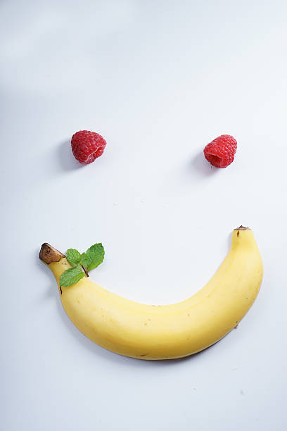 istock smile shape banana and raspberries 516647156
