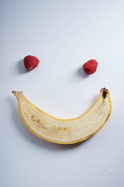istock smile shape banana and raspberries 516647368