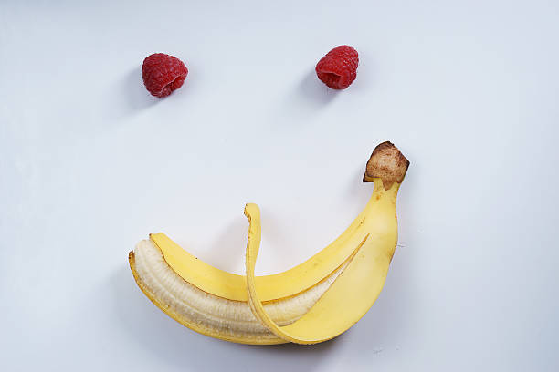 istock smile shape banana and raspberries 516647486