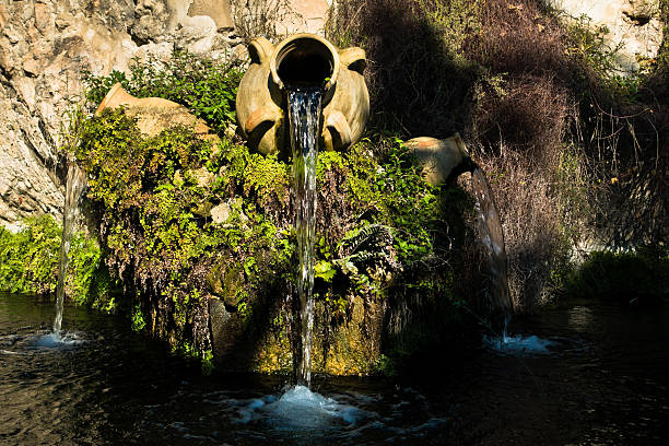 Fountain in a park with water flowing from an old amphora, Cagliari, Sardinia, Italy
