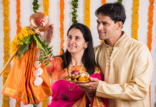 istock smart indian couple performing gudhi padwa puja 516647820