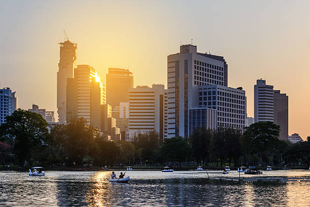 istock Bangkok skyline and urban lake in summer. 516649420