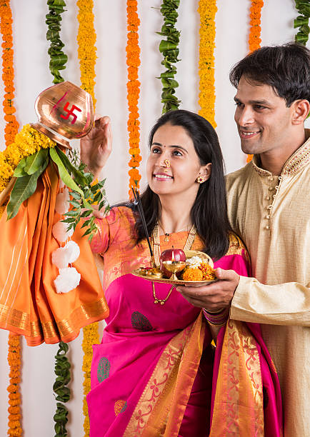 istock smart indian couple performing gudhi padwa puja 516650624
