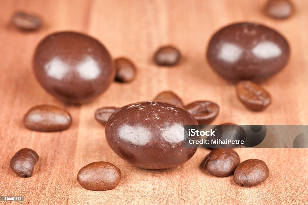 Chocolate candy and coffee beans Chocolate candy and coffee beans on a wooden board Bean Stock Photo