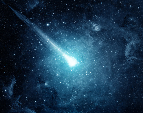 Comet in the starry sky. Elements of this image furnished by NASA.